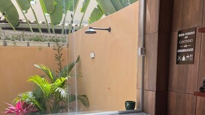 A room with a window overlooking a garden, a small table, and two chairs. - Vacation Rental for Carnival - Furnished Apartment" "Carnival 2026 (salvador)