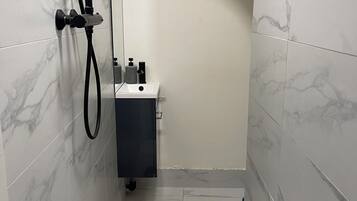 Shower, hair dryer, towels, toilet paper