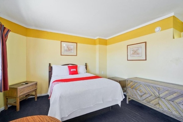 Unwind on crisp linens in a bright, spacious room.
