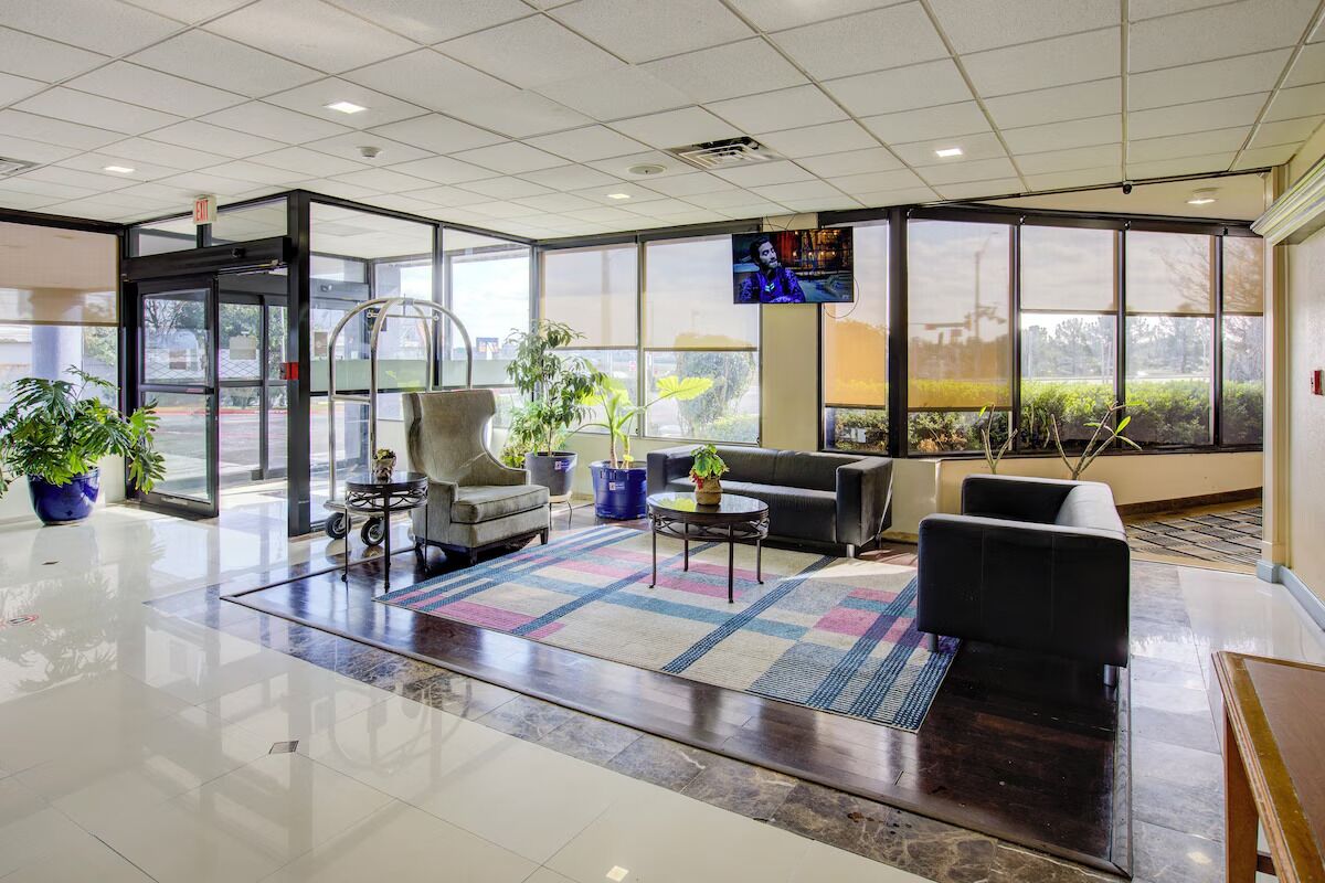 Unwind in the bright lounge with cozy seating and big windows.