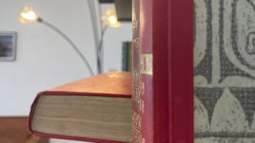 A stack of books with a patterned bookend.