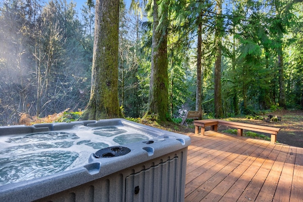 Soak in your private hot tub surrounded by towering forest trees, where warm bubbles and fresh mountain air create pure tranquility.