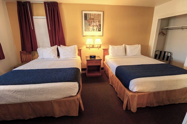 Drift off comfortably with bedside lamps and crisp linens.