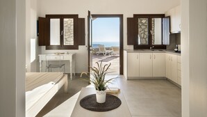 A modern kitchen with a view of the sea, a dining area with a plant, and a small office space. - Villa - Sleeps 5 - Private Heated Pool-parking (Pyrgos)