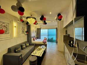 Panoramic Studio Suite, Balcony, River View | Living area | 40-inch Smart TV with digital channels - Mulberry Homes Supernova (Noida)