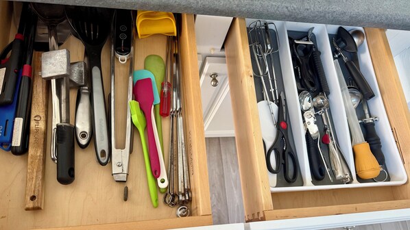 A drawer with various kitchen utensils and tools, including a knife, spatula, and whisk. - The Stillwater - Pool, Riverfront & Viewing Dock - Close to Speedway & Downtown! (Daytona Beach)
