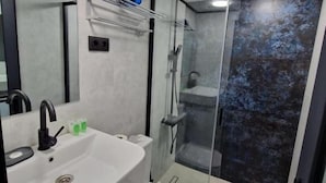 A modern bathroom with a large sink, toilet, and a glass-enclosed shower area. - Glamping Georgia - Krikhi  (Ambrolauri)