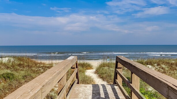 A wooden boardwalk leading to the beach with a clear view of the ocean. - Amelia Island 3 Bedroom Sea Escape (Fernandina Beach)