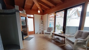 A spacious living area with a wooden floor, a fireplace, a sofa, and a coffee table. - Villa Diva (Budureasa)