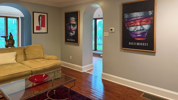 A living room with a sofa, a glass coffee table, and a red bowl. There are two framed posters on the wall and a statue on the left. - STAFFORD ESTATE IN HISTORIC PHILADELPHIA (Philadelphia)