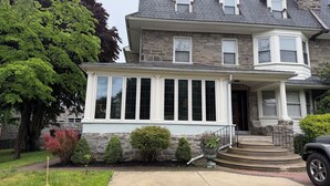 A two-story house with a stone facade, large windows, and a front porch. - STAFFORD ESTATE IN HISTORIC PHILADELPHIA (Philadelphia)