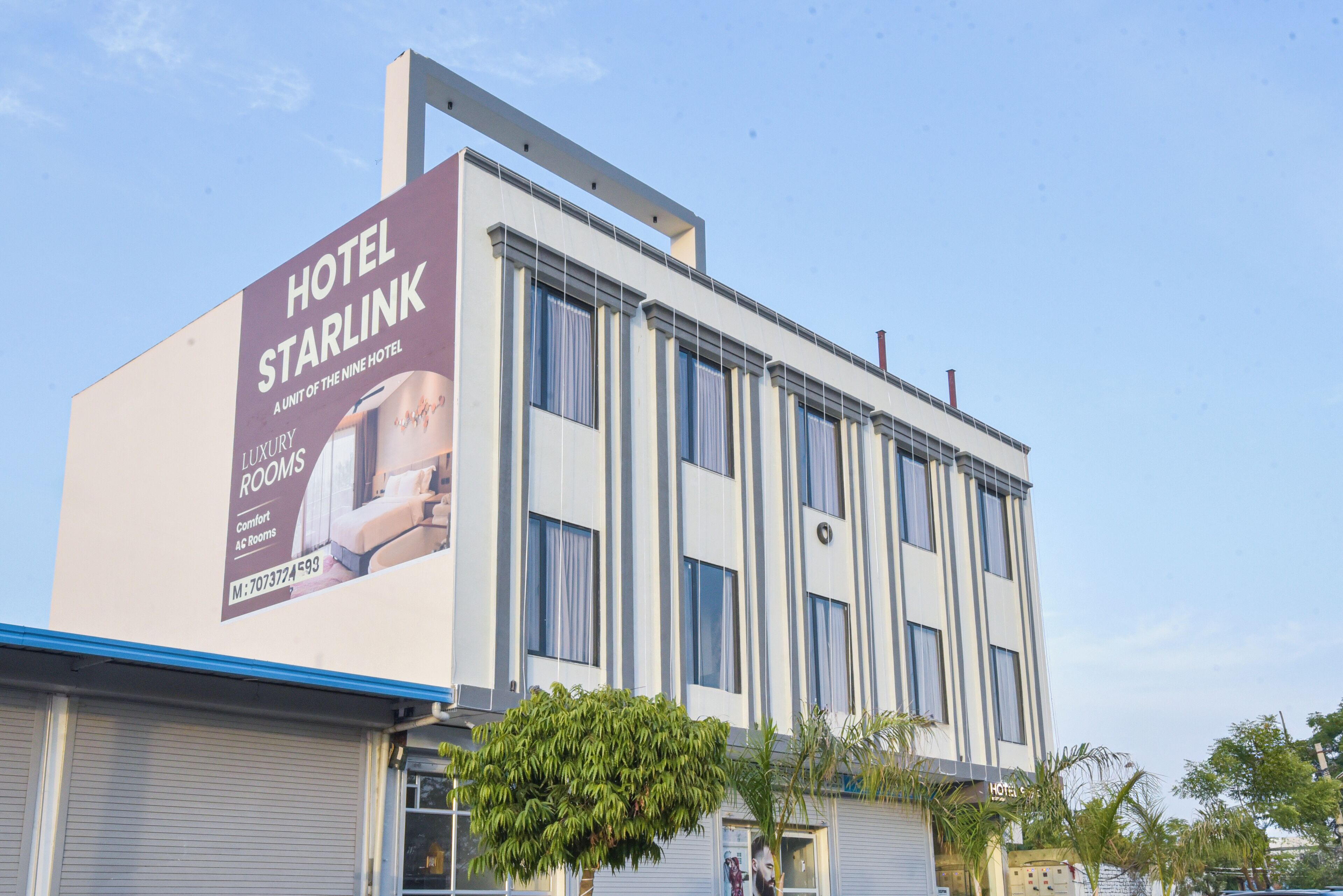 Un edificio de hotel con un gran anuncio que promociona habitaciones de lujo.