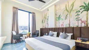A hotel room with a large bed, two chairs, a desk, and a large window with curtains. - Hotel Starlink By The Nine Hotel  (Jaipur)