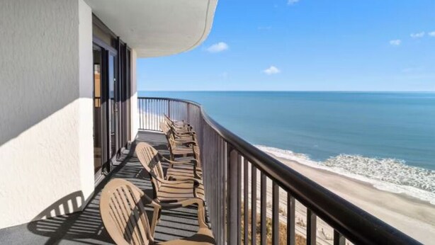 A balcony with a view of the ocean.