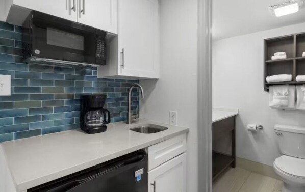 Fridge, microwave, coffee/tea maker, cookware/dishes/utensils