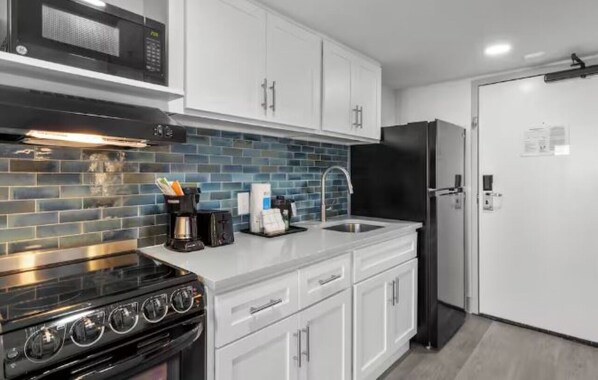 Fridge, microwave, coffee/tea maker, cookware/dishes/utensils