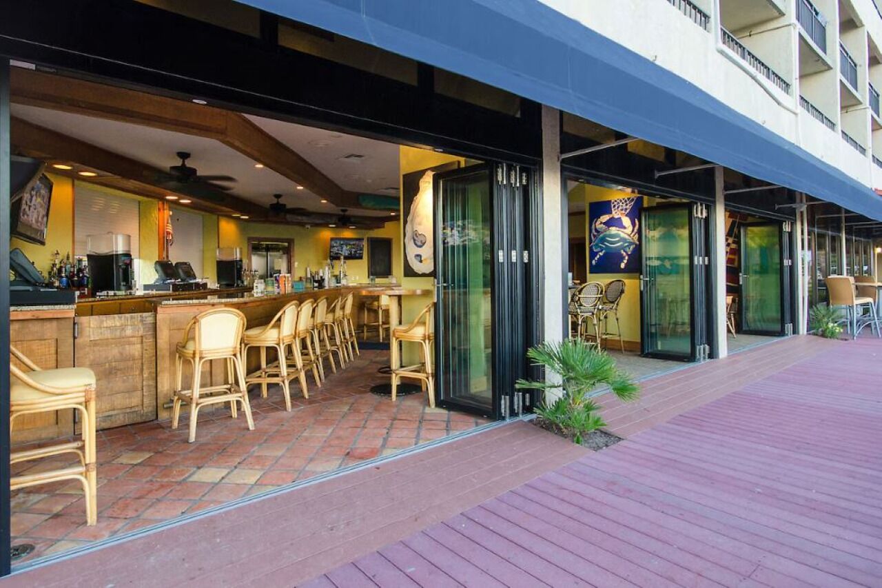 An outdoor bar area with wicker chairs and a counter.