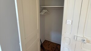 A walk-in closet with wooden flooring and white doors. - COTTAGE L'OUSTAL ideally located beach and seawall 100 meters away (Le Crotoy)