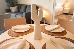 A dining table with a unique centerpiece, surrounded by placemats and napkins. - Luxury Maho Entire Apt 1BR Ocean Runway View (Maho)