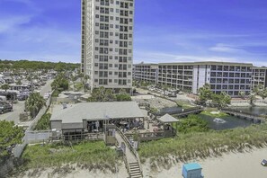 A coastal hotel with a beachside location, a parking area, and a small dock over water. - 2BR/2BA- Pools- Myrtle Beach Seabreeze 329 (Myrtle Beach)