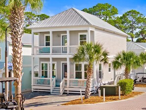 A two-story house with a balcony, a porch, and a garage.