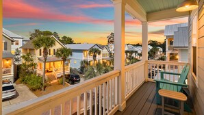 A residential area with a porch, a green chair, and a car parked outside. - 30A Home for 10: Pool, Golf Cart & Chef's Kitchen, Open-Concept Living (Santa Rosa Beach)