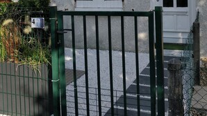 A building with a white door and windows, a green gate, and a number '4' sign. - Cosy quiet house 4 persons, parking & bikes, Royan  (Royan)