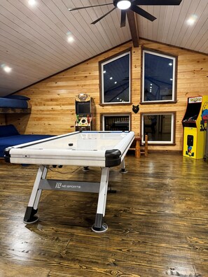 A pool table in a room with wooden walls and large windows. - The White Oak Cabin at Cabins of Wolf Pen Gap (Mena)