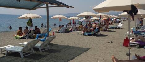 Private beach, white sand, sun loungers, beach umbrellas