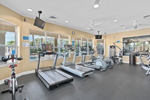 A gym with treadmills, elliptical machines, and stationary bikes. - Minutes to the Magic! Spacious 3 BR condo w/pool, water park & water slides! (Kissimmee)