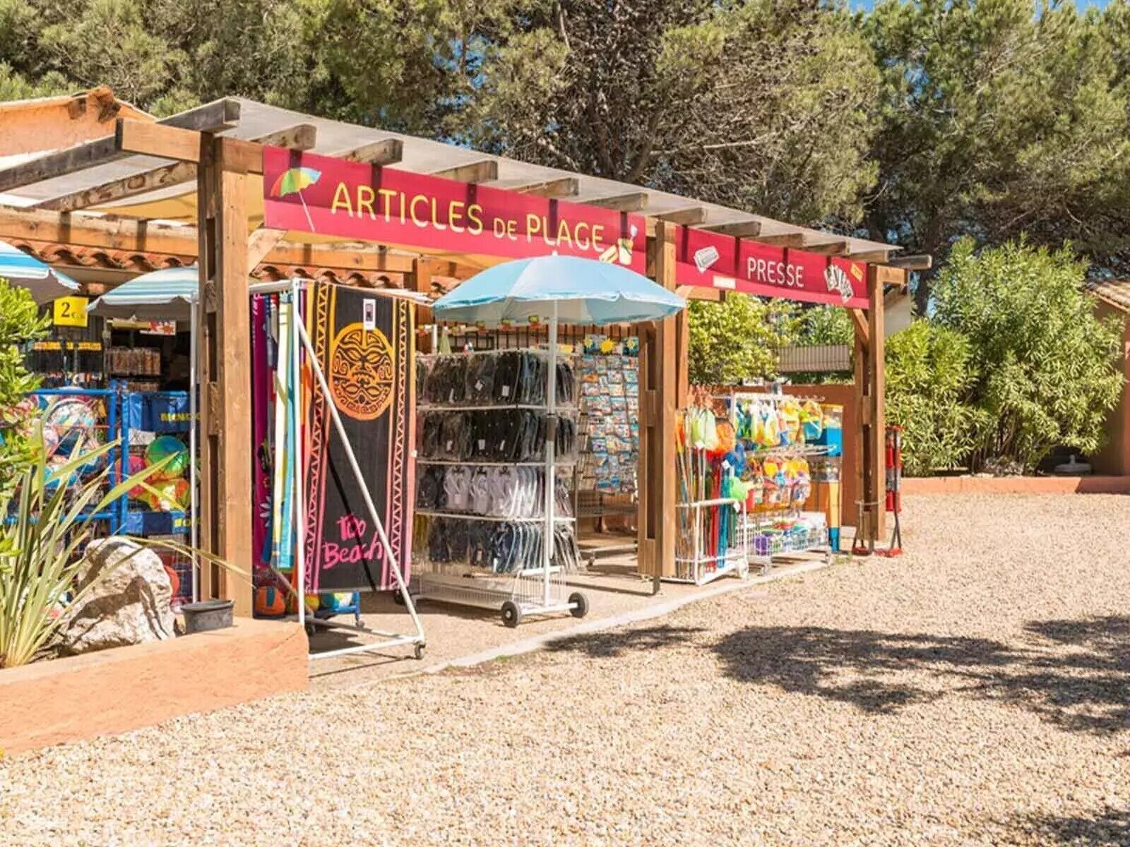 A beach-themed outdoor kiosk with a wooden structure, selling beach-related items.