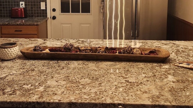 A kitchen with a wooden island, a stainless steel refrigerator, and a hanging light fixture with exposed bulbs. - 3-bedroom home with great  backyard  & pool with a  private and peacful setting (Spring Hill)