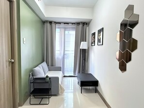 Living area - S Residences premiere MOA 3rd T1 floor 1BR w/balcony by darpm (Pasay City)