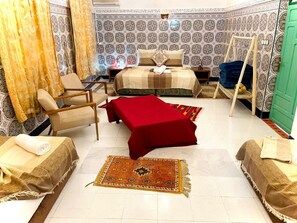 A hotel room with a bed, two chairs, a table, and a small sofa. - riad la joie (Marrakech)