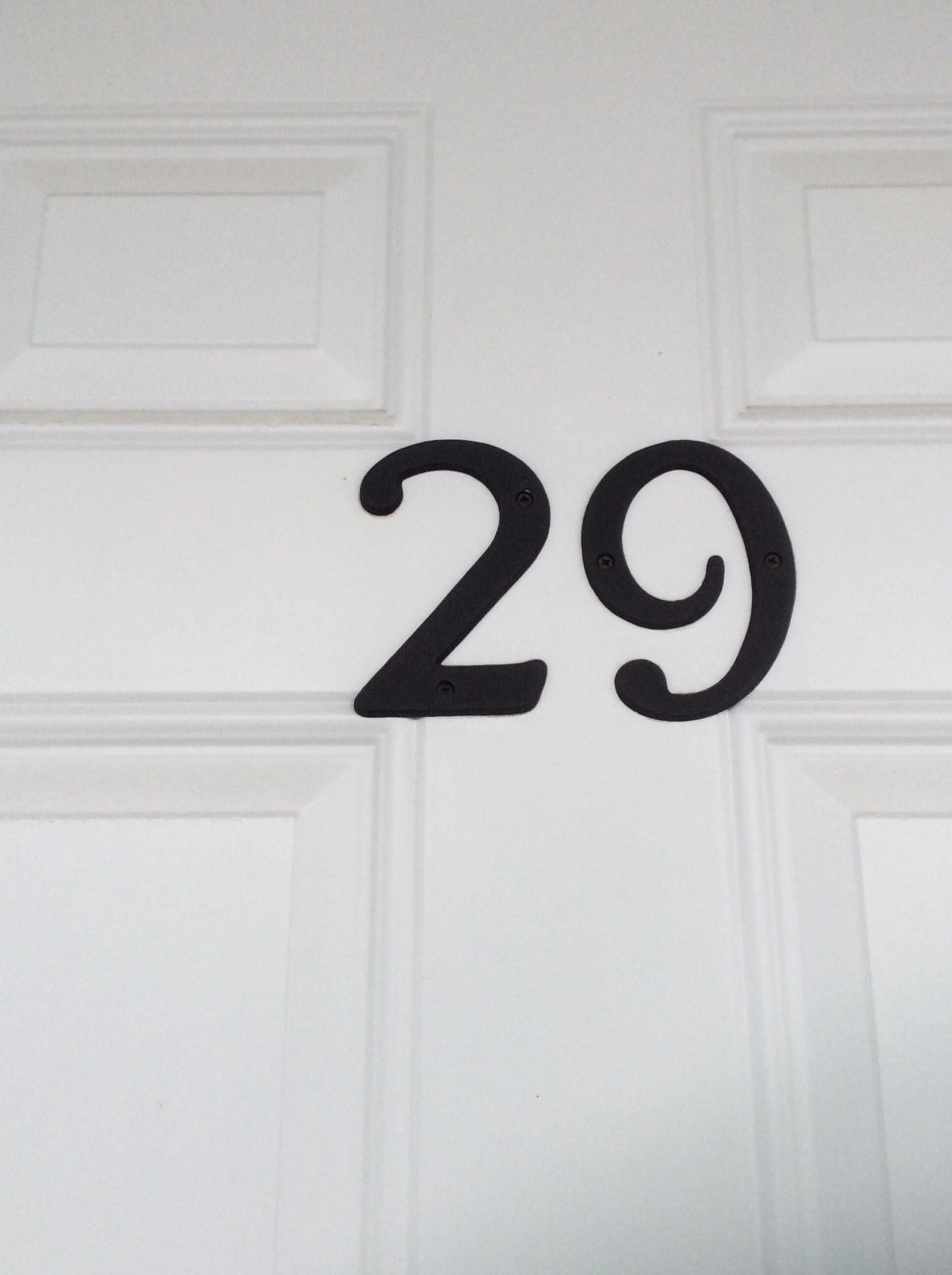 A white door with a black number '29' indicating a room number.
