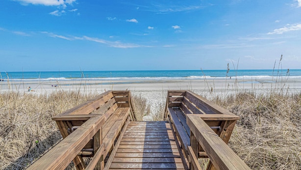 A wooden boardwalk leading to a beach with clear skies. - Steps to Beach, Private Pool, Sleeps 14 | Sea Gem (Surfside Beach)
