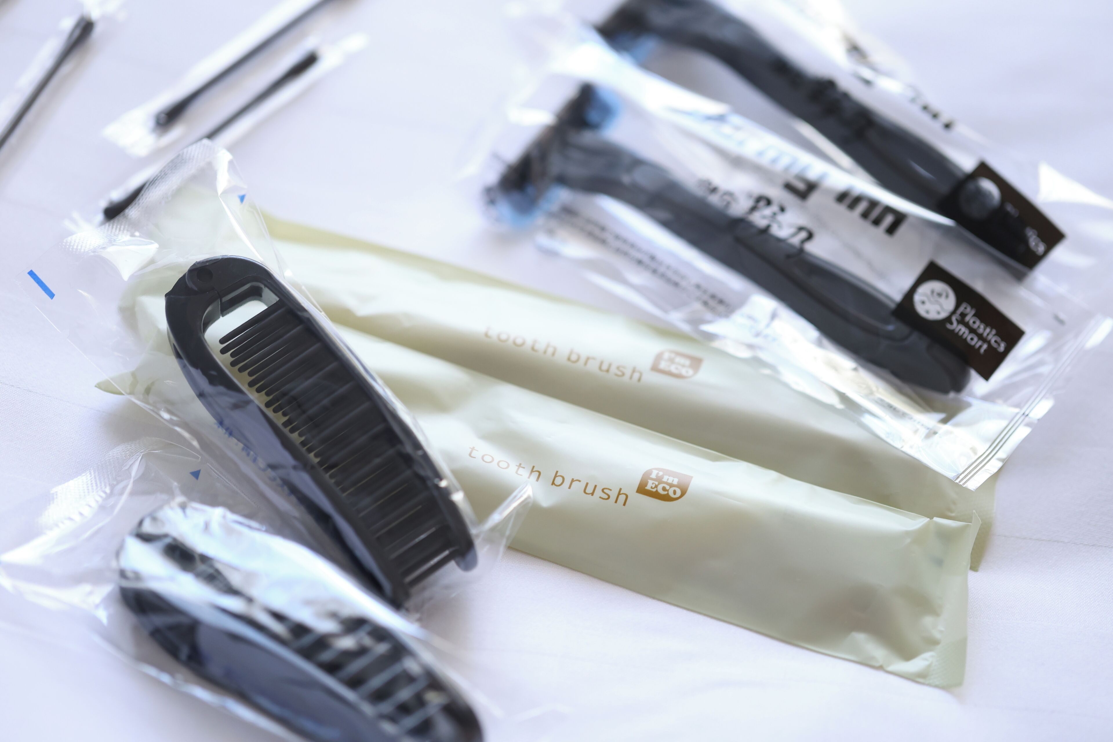 A package of toothbrushes and a toothbrush holder.