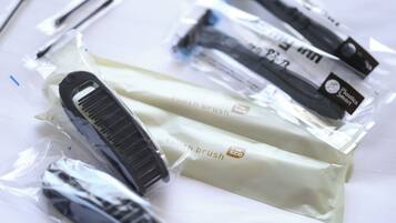 A package of toothbrushes and a toothbrush holder.
