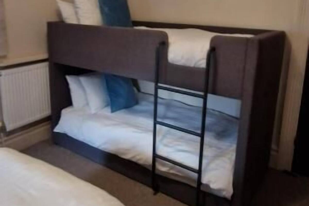 A bunk bed with a lower bunk and a separate bed below.