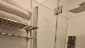 A glass-enclosed shower stall with a towel rack above it. - Black Sheep Lodge (Holyhead)