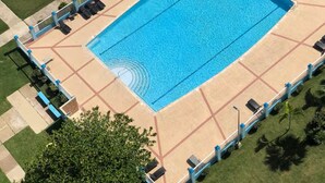 A swimming pool with a surrounding deck, a tennis court, and a basketball court. - -- NEW -- Paradise & Luxury II Seaside Sanctuary Ocean Views & Fully Renovated (Luquillo)