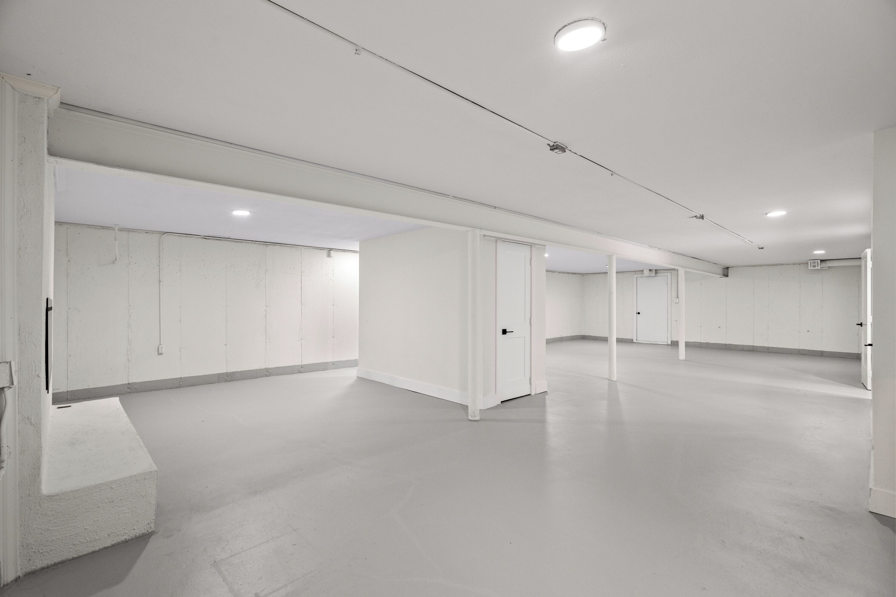 Quarto de hotel espaçoso e moderno, com layout amplo, teto plano e design minimalista.