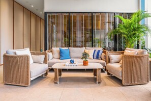 A modern living room with a sofa set, two armchairs, and a coffee table.