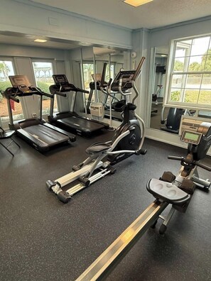 A gym with treadmills, an elliptical, and a stationary bike. - Blue Horizon - Oceanfront House on Harbor Island (Harbor Island)