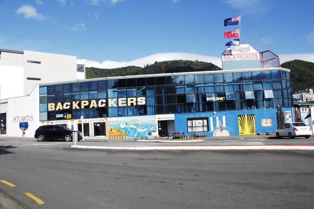 A building with a sign reading 'BACKPACKERS' and 'ATLANTIS'.