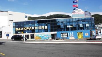 A building with a sign reading 'BACKPACKERS' and 'ATLANTIS'.
