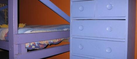 A bunk bed with a lower bunk and a dresser with four drawers.