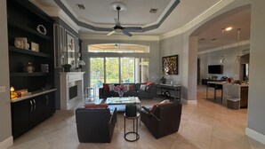 Un amplio espacio de sala de estar con chimenea, una mesa de comedor y asientos cómodos.