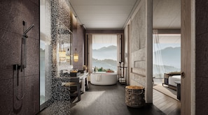Une salle de bain moderne avec une baignoire sur pieds, un grand miroir et une vue sur les montagnes.