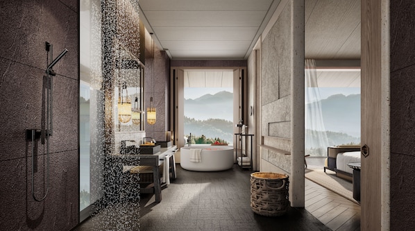 A modern bathroom with a freestanding bathtub, a large mirror, and a view of mountains.